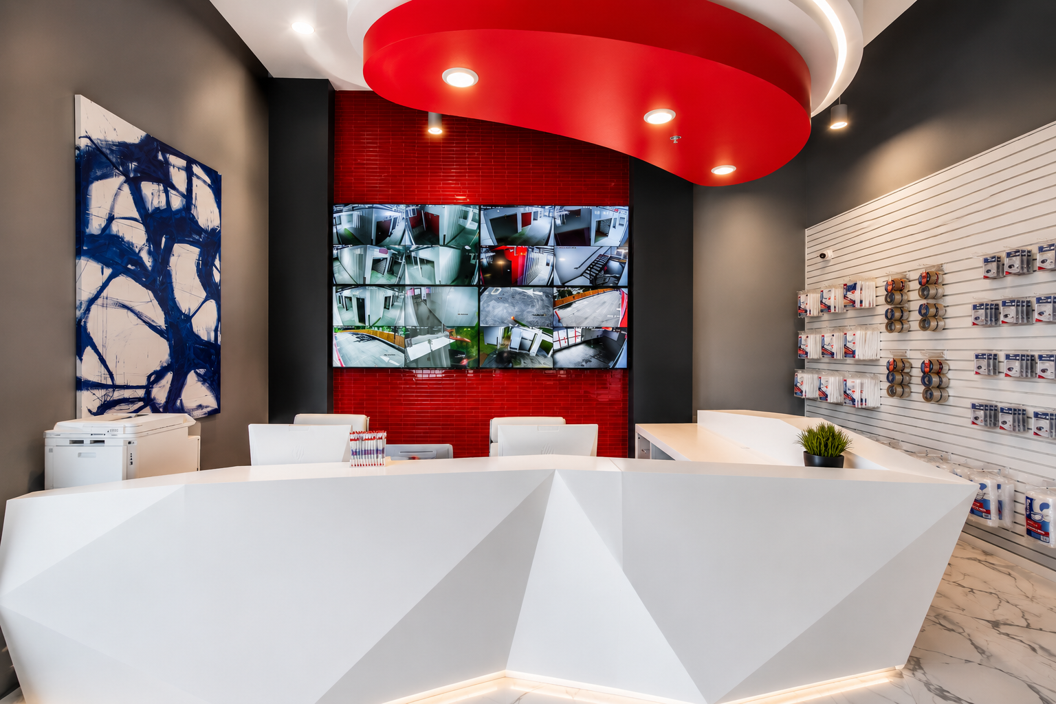 Modern Storage® Bryant front desk with white geometric counter, red ceiling accent, storage display wall, and bright lobby design